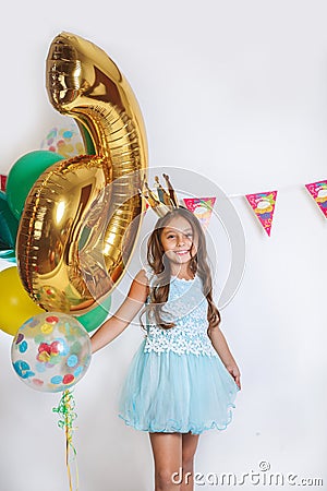 Beautiful little princess in blue dress. Birthday party for cute child. Stock Photo