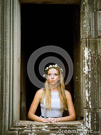 Beautiful, Lonely Fairytale Princess Looking Out the Tower Window Stock Photo