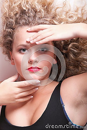 Beautiful long blond curly hair of young attractive woman Stock Photo