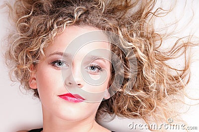 Beautiful long blond curly hair of young attractive woman Stock Photo