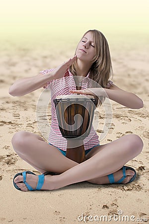 Djembe drummer playing on the beach Stock Photo