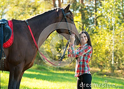 Beautiful long hair young woman with a horse outdoor Stock Photo