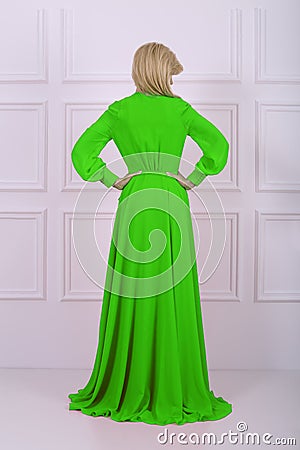 Beautiful long haired woman in green dress Stock Photo