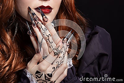 Beautiful long sharp black graft acrylic nails image for witches Stock Photo