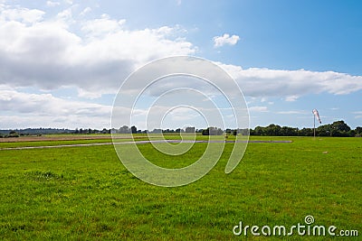 Beautiful long shot of a field used as a takeoff/landing runway for planes Stock Photo