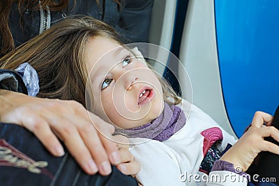 Beautiful look of girl lying on leg of her mother Stock Photo