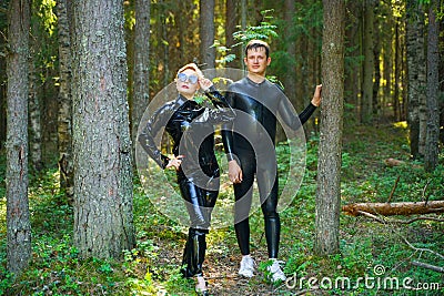 Beautiful loving couple posing in latex rubber costumes Stock Photo