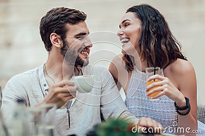 Beautiful loving couple sitting in a cafe enjoying in coffee Stock Photo