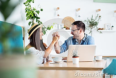 Beautiful loving couple sitting in a cafe enjoying in coffee and conversation Stock Photo