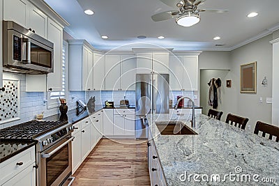 Beautiful luxury kitchen with quartz and granite countertops and white cabinets Stock Photo