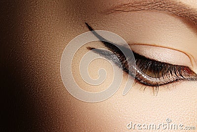 Beautiful Macro Shot of Female Eye with Classic Eyeliner Makeup. Stock Photo