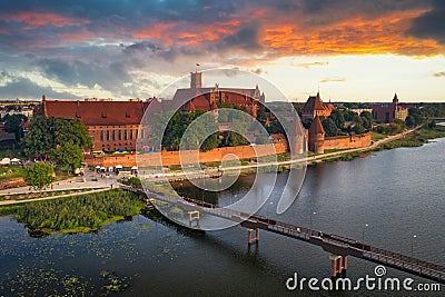 Beautiful Malbork castle over the Nogat river at sunset, Poland Editorial Stock Photo