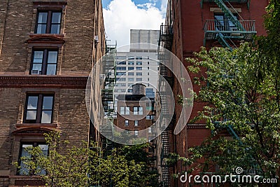 Manhattan Alley with Old Brick Skyscrapers with Fire Escapes and an Old Water Tower on the Upper West Side of New York City Stock Photo