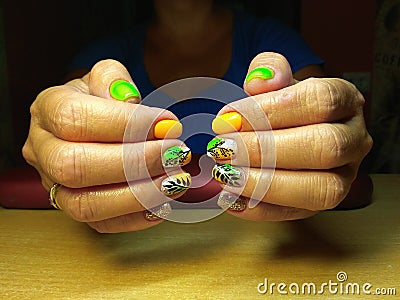 The manicurist excellently made her work a beautiful manicure with a polish gel on her hands and the client is happy Stock Photo