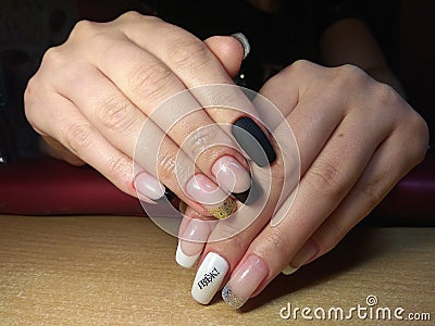 The manicurist excellently made her work a beautiful manicure with a polish gel on her hands and the client is happy Stock Photo