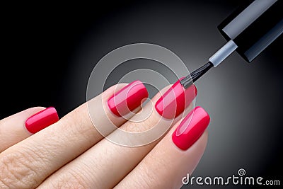 Beautiful manicure process. Nail polish being applied to hand, polish is a pink color. Stock Photo