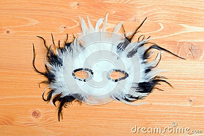 Beautiful mask of feathers on a yellow board Stock Photo