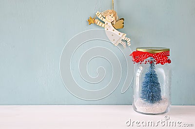 beautiful mason jar with christmas tree and flying angel Stock Photo