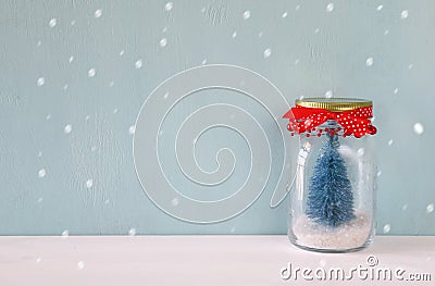 beautiful mason jar with christmas tree. Snow overlay Stock Photo