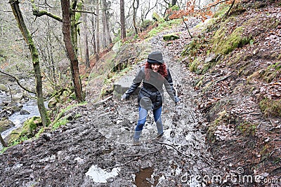 Beautiful mature brunette outraged by being stuck in mud Stock Photo