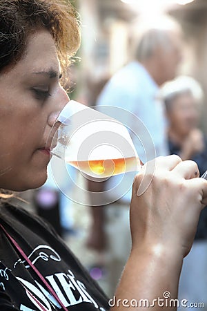 Woman tasting a glass of white sparklig wine. Color image Stock Photo