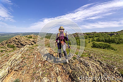 beautiful mature women travels through the mountains Stock Photo