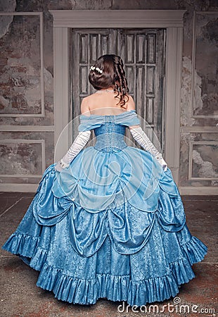 Beautiful medieval woman in blue dress, back Stock Photo