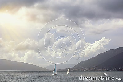 Beautiful Mediterranean landscape. Sailboats sails near shore of Kotor Bay. Montenegro. Travel concept Stock Photo