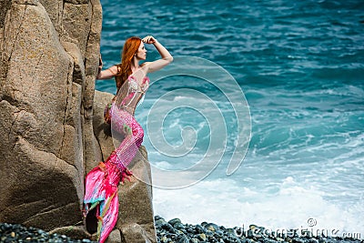 Beautiful mermaid on sea shore Stock Photo