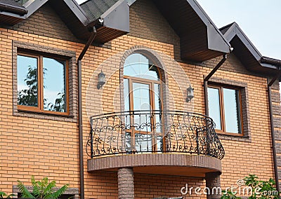 Beautiful metal balcony. Brick house. Stock Photo