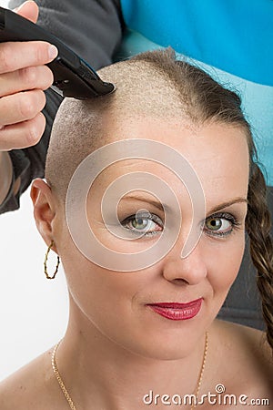 Beautiful middle age woman cancer patient shaving hair Stock Photo