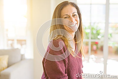 Beautiful middle age woman smiling at home Stock Photo