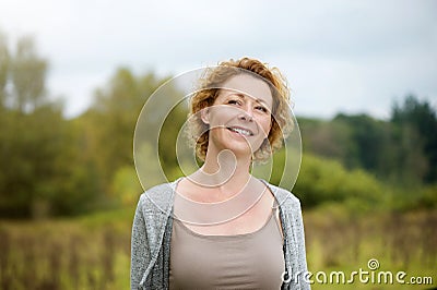 Beautiful middle aged woman smiling outdoors Stock Photo