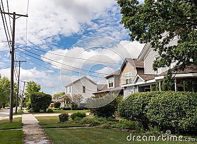 Midwest Neighborhood Street and Sidewalk with Old Homes and Green Trees during the Summer in Lemont Illinois Stock Photo