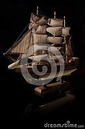 Beautiful miniature ship. Wooden ship figurine. Antique model sailing ship isolated with clipping path. Model of ship with sails Stock Photo