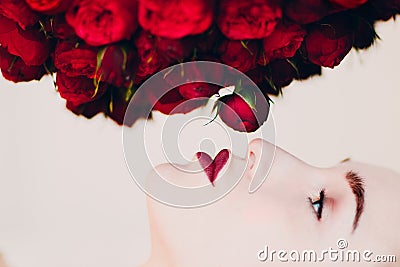 Beautiful model and flowers. Pion - shaped roses bouguet. Stock Photo