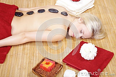 Beautiful model at wellness massage with hot stone Stock Photo