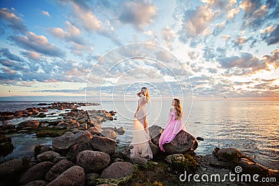 Beautiful Models Woman on Sunset Coast Outdoors Stock Photo