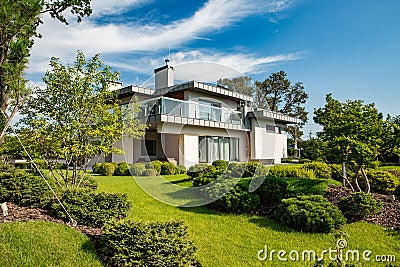 Beautiful modern house in cement, view from the garden. Stock Photo