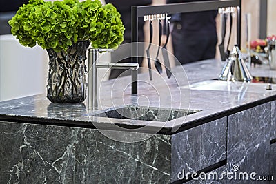 Beautiful modern kitchen design, kitchen faucet and kitchen decor, gray marble kitchen island Stock Photo