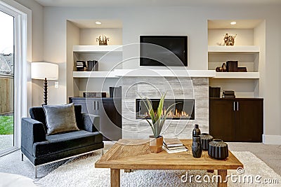 Beautiful modern living room interior with stone wall and fireplace in luxury home Stock Photo