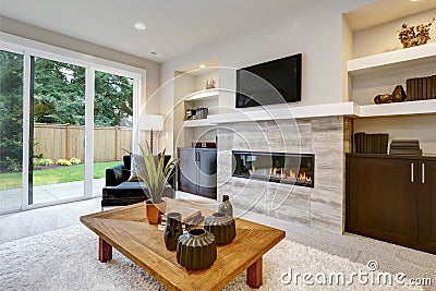 Beautiful modern living room interior with stone wall and fireplace in luxury home Stock Photo