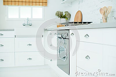 Beautiful modern white kitchenette with window, sink and oven. Kitchen interior and decor Stock Photo