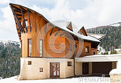 Beautiful modern wooden house covered in snow, ski resort Donovaly Stock Photo