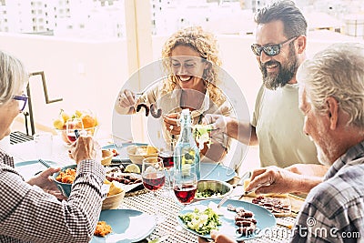 Beautiful moment of family lifestyle at home eating and drinkng food or drinks at home on the table - man with sunglasses tking a Stock Photo