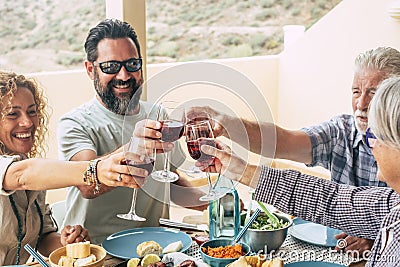 Beautiful moment of family lifestyle at home eating and drinkng food or drinks at home on the table - man with sunglasses tking a Stock Photo