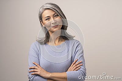 Beautiful Mongolian Woman with Gray Hair on a White Background. Stock Photo
