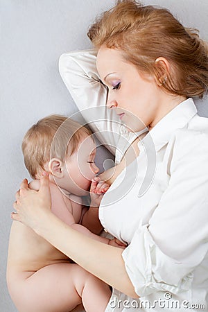 Beautiful mother breast feeding her baby boy Stock Photo