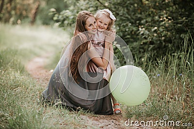 Beautiful Mother And her little daughter outdoors. Nature. Outdoor Portrait of happy family. Happy Mother`s Day Joy Stock Photo