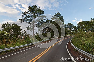 Beautiful mountain asphalt road with curve and double yellow lin Stock Photo